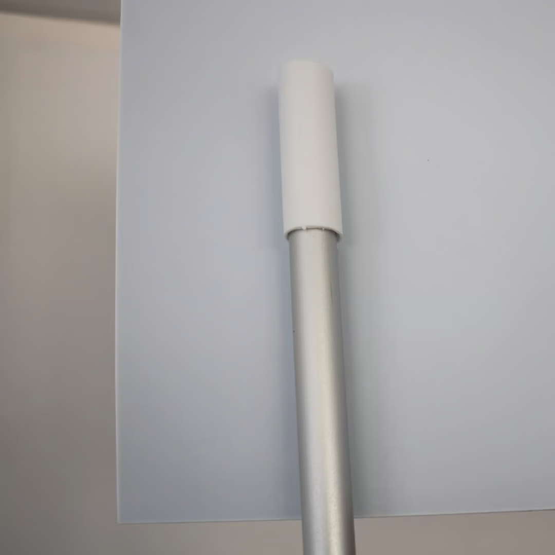 Silver support pole locating into the plastic mounting cup on the back of the header panel